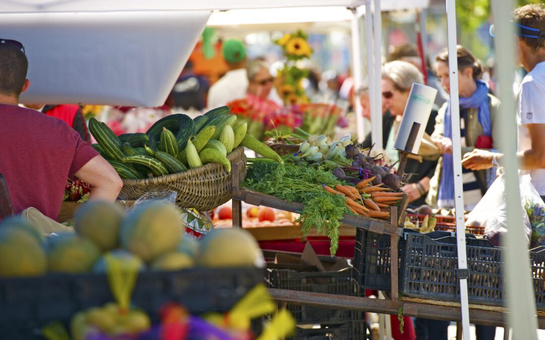 Outdoor farmers market in Bryan, Texas with fresh vegetables and local vendors.