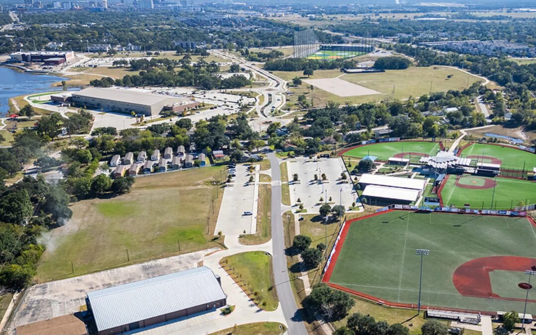 Aerial view of Travis Bryan Midtown Park in Bryan Texas showing baseball fields, Topgolf, and surrounding Midtown neighborhood