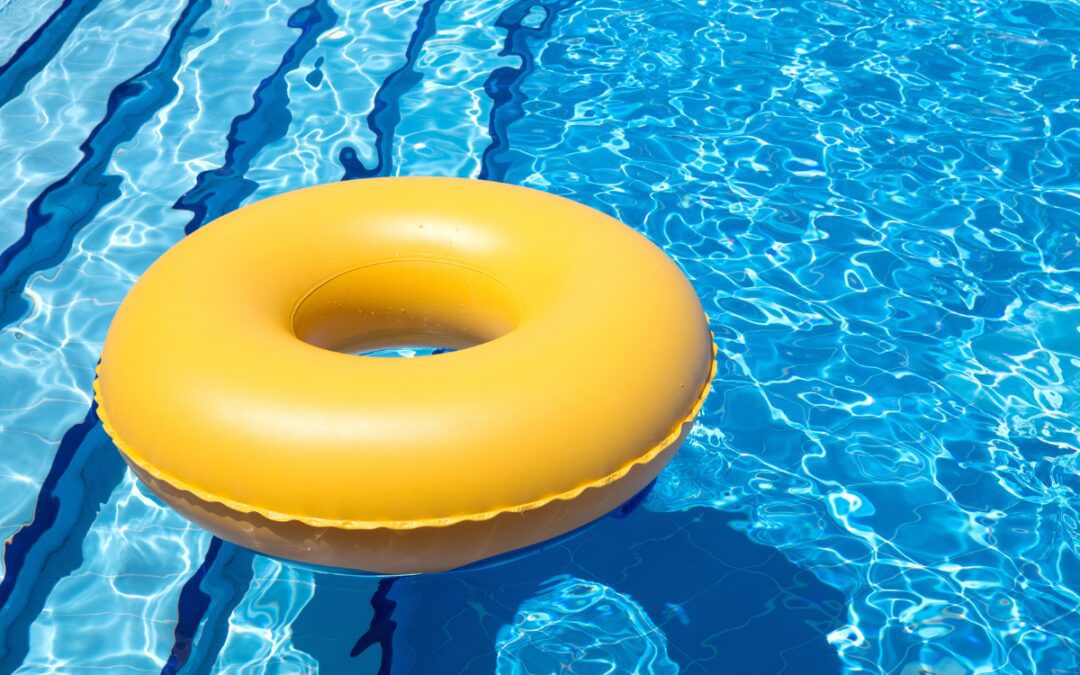 Yellow inflatable pool float in a sparkling blue lap pool representing summer swimming spots in Bryan-College Station