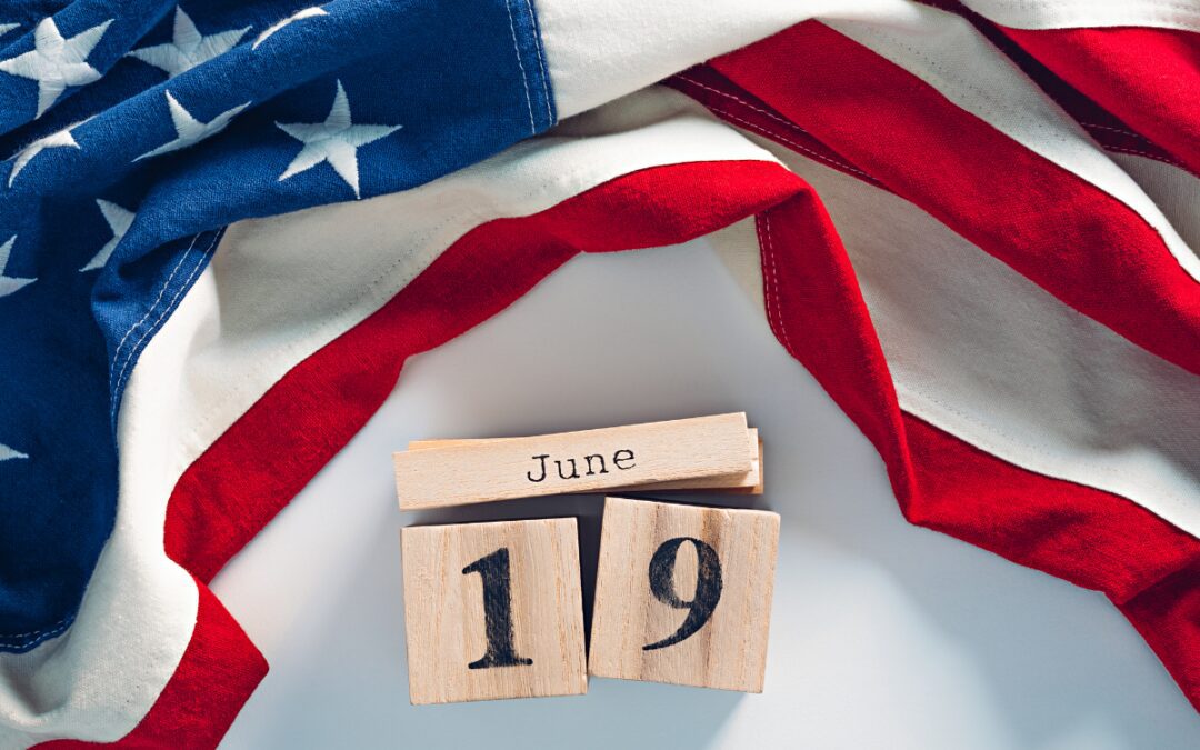 Wooden calendar blocks showing June 19 surrounded by an American flag representing Juneteenth celebrations in Bryan Texas