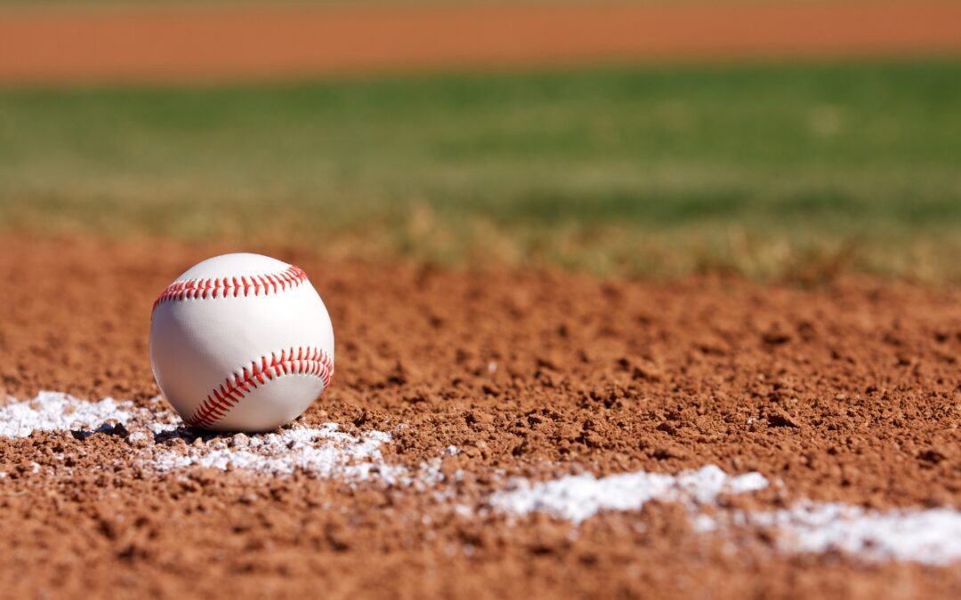 Baseball resting on the infield dirt near the chalk line at a Bryan Yard Dogs game